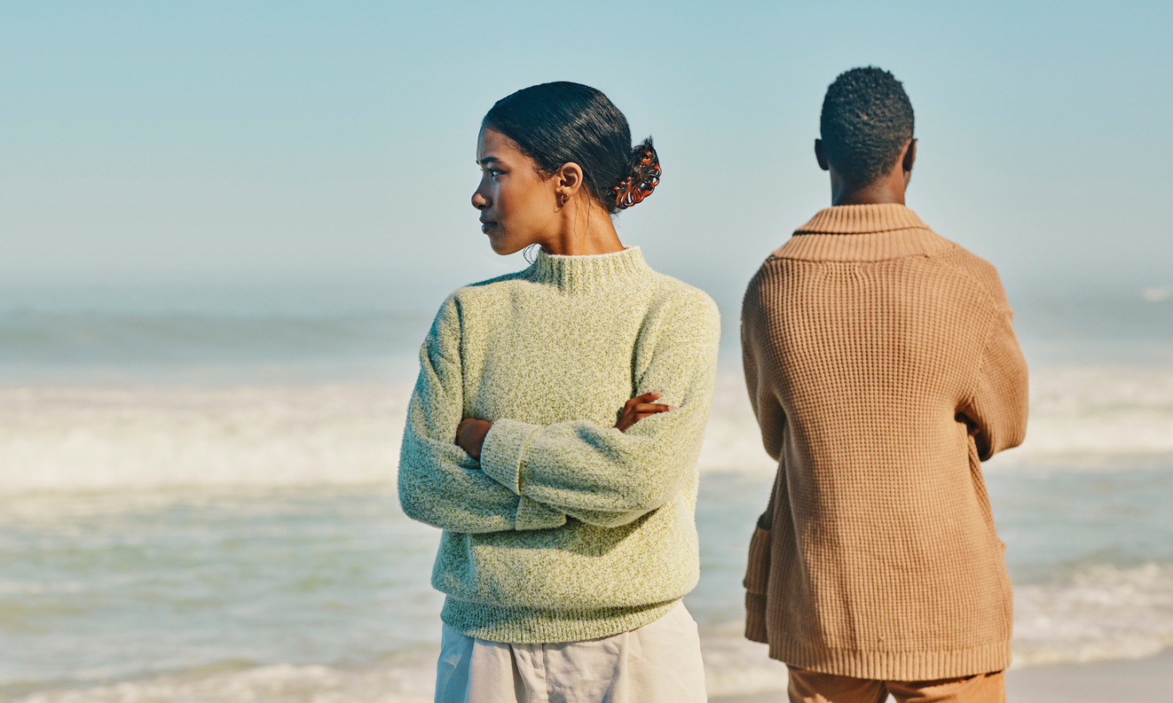 Couple facing away from either by the ocean
